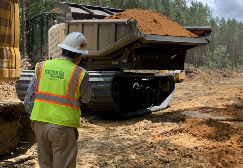 Sequoia Services worker overlooking a loader full of soil